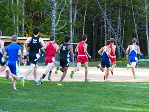 As the leaders went past me at the start, and nearly where they ended up:  Ben T. (senior) in the lead, Caleb (freshman) and Eli (sophomore).  Ben W. isn't in this picture, but he was able to avoid getting boxed in and finished in the top ten for the first time this season!