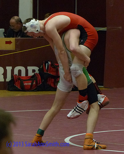 Earlier in the season, the kid from Massabesic tooled all over Eli at a duals (regular season) meet.  Eli was in a better frame of mind this day, but Eli told me the Massabesic kid is **really good** on his feet.  You don't often see Eli in this position, about to get dumped! (Eli is in red, Massabesic -- a Class A school from the southern part of the state -- is in white-green-yellow.