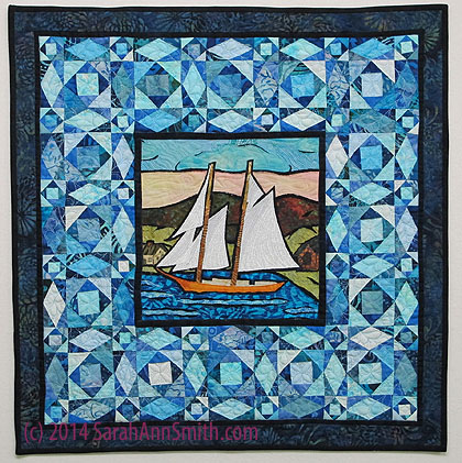This may be one of my favorite quilts.  It is inspired by a beer carton (for our grocery challenge, see blogposts here).  I revised the harbor to be Camden and the schooner to be the Louis B French.  The miniature storm at sea is mostly from a John Flynn quilt kit, with the small square in a square finishing at (EEEK) 1 1/8".  At least when I pieced them accurately!  Finished size is 20 1/2" square.
