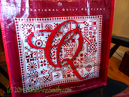Barb Black's beautiful red and white quilt on the 40th Anniversary International Quilt Festival show bag.  GO BARB!