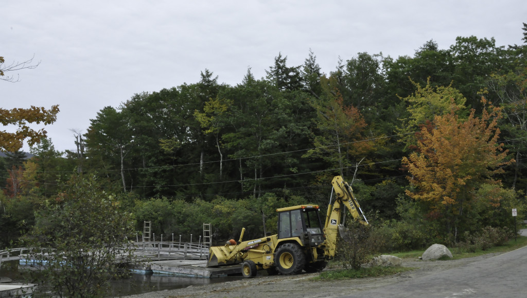 May I just say how much I love content aware fill????   Fixed several raindrops on the lens!  Cropped to eliminate extra sky and parking area.  This is at the boat launch on Lake Megunticook, Route 105.  A sure sign that autumn is well under way is the removal of all rafts and docks from the water.  They are stored on the other side of the road, cloaked in snow, until they migrate back across the road and into the lake.  Ice out is usually mid-April, so in the water in May sometime.  Not a typical shot of autumn, but it is OUR autumn here in mid-coast Maine.