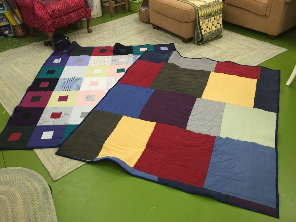 The two lap quilts, the one with the sweatshirts on the back is on the right, back side up. Can I just say it weighs a flipping TON! 